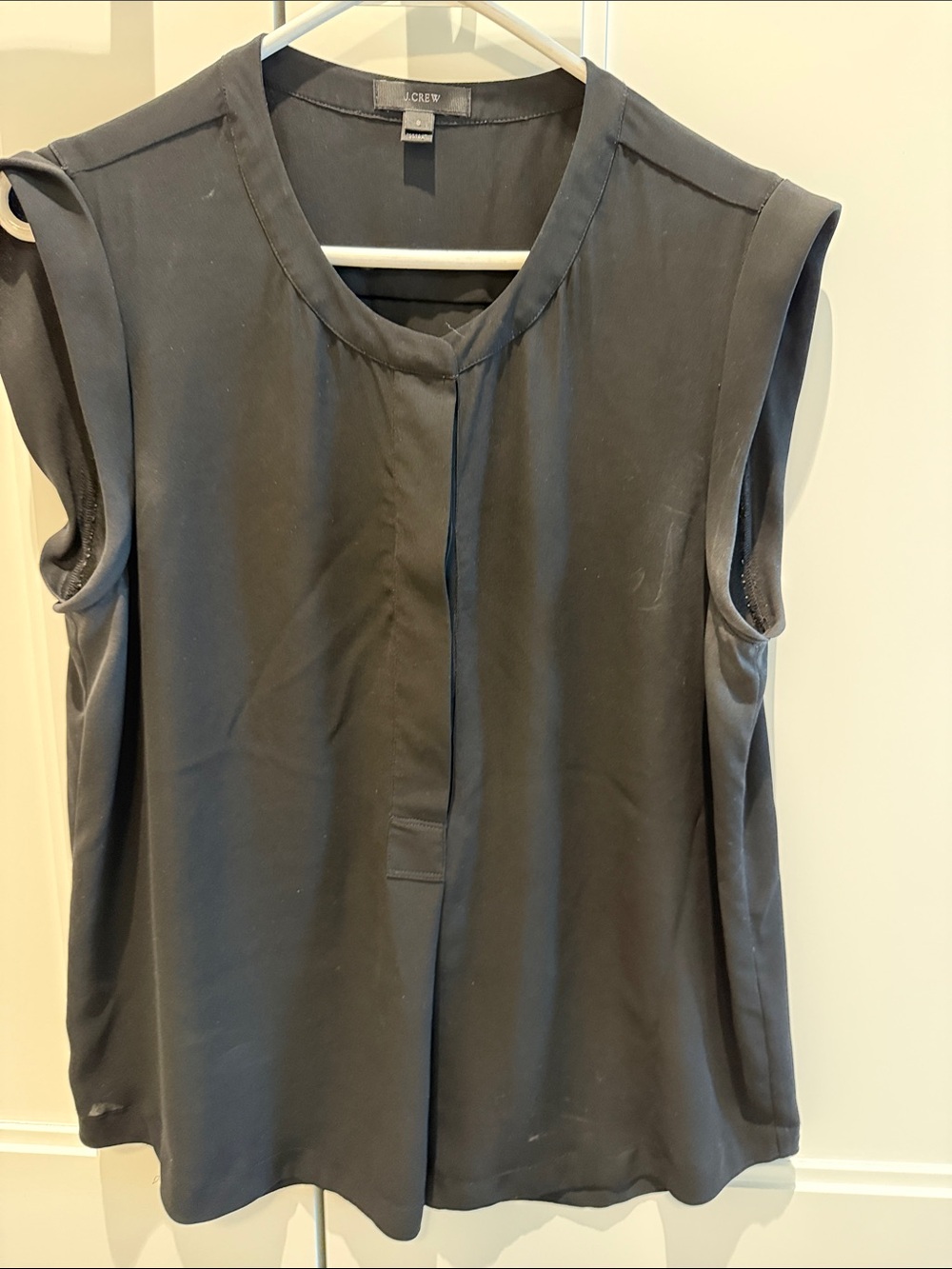 J. Crew Sleeveless black blouse with covered buttons